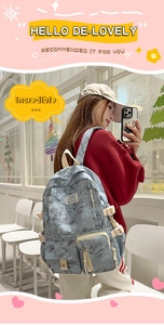 Detail of school backpack featuring marble texture, multiple pockets and side drawstrings