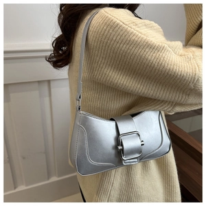 Detail of silver faux leather shoulder bag with metallic finish and large square buckle