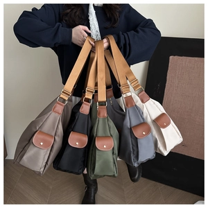 Close-up of lightweight nylon crossbody bags in multiple colors with adjustable straps