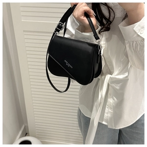 Detailed shot of the black leather texture and Fashion Trend silver lettering on the bag