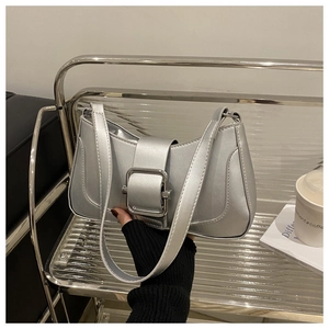 Metallic silver baguette bag featuring a large square buckle and sleek shoulder strap