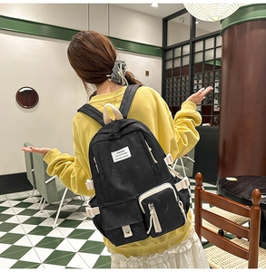 Student backpack with adjustable buckles shown from the back in a stylish indoor setting
