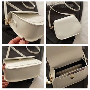 Detail view of white saddle bag with houndstooth flap and golden hardware accents