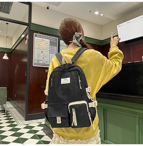 Detailed view of large capacity black and white student backpack with functional pockets