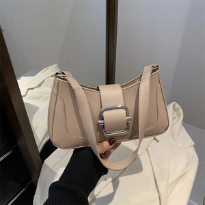 Chic beige underarm baguette bag featuring a silver square buckle and smooth leather finish