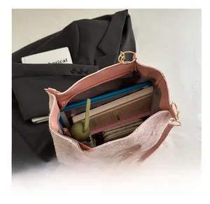 Detail view of pink tote bag showing large capacity for umbrella, notes and wallet