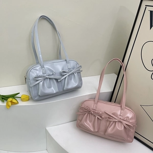 Détail de cabas bleu clair et rose poudré avec poches à cordon nœud sur support minimaliste