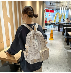 Detail view of a large marble pattern school backpack worn in a casual lifestyle setting