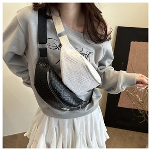 Detail of woven texture chest bags in black and white with adjustable straps