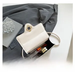 Interior storage view of cream square bag with gold clover clasp and makeup items