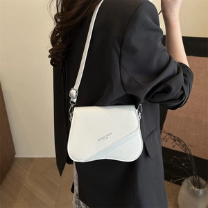 Minimalist white square crossbody bag with irregular flap on black blazer outfit