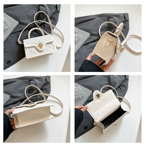 Detail view of cream white crossbody bag with clover lock and woven handle design