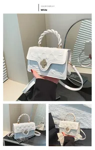 Detail of white leather handbag with 3D floral texture and woven handle design