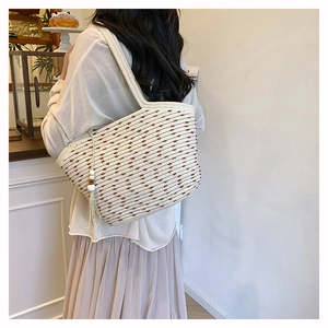 Detail of hand-woven tote bag with brown stripes, cotton rope texture and wooden bead tassel