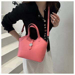 Detail of pink vintage bucket bag showing fine PU leather texture and silver buckle