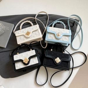Detail view of four mini square bags with flower twist handles and gold petal twist locks