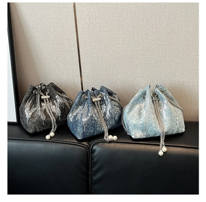 Close-up of denim bucket bags featuring wave sequins and silver chain drawstring