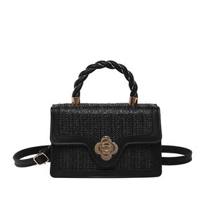 Minimalist black woven crossbody bag with gold flower lock and twisted rope handle