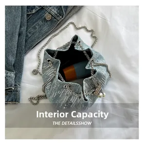 Macro view of denim bucket bag interior showing large capacity for cosmetics