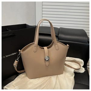 Macro detail of beige matte leather handbag with wavy edge and silver twist lock