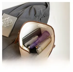 Spacious interior of beige tote bag showing tablet, phone, and daily essentials storage