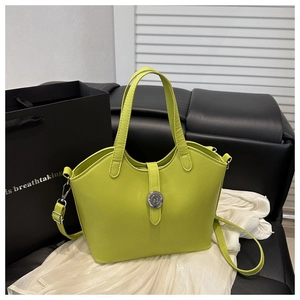 Detail of lime green bucket bag with adjustable strap and decorative metal buckle