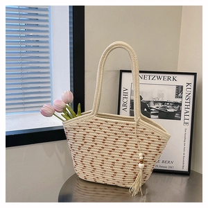 Close-up of woven cotton rope tote bag with wooden bead tassel and tulip decoration