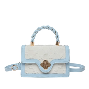 Fashionable sky blue and cream crossbody bag with floral clasp and braided handle