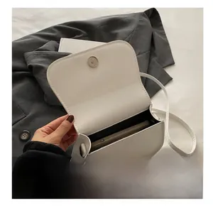 Interior view of white leather crossbody bag showing spacious storage for smartphone