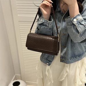 Deep brown woven leather underarm bag with gold metal hardware and slim strap