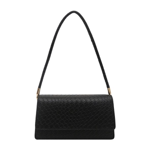 Minimalist black woven texture shoulder bag with gold metal hardware on white background