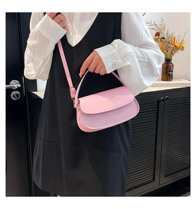 Detail of pink PU leather saddle bag with glitter patchwork and adjustable strap