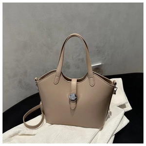 Detail of minimalist beige faux leather handbag with silver metallic hardware and top handles