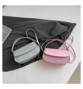 Detail of pink and gray crossbody bags featuring glitter patchwork and matte PU texture