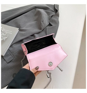 Detailed view of pink sequin evening bag with silver chain and magnetic closure