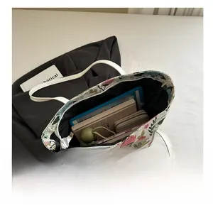 Internal view of floral canvas tote bag showing large capacity for tablet and notebooks