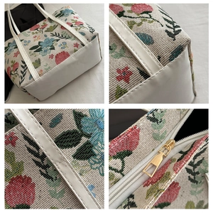 Detailed views of floral jacquard tote bag featuring white faux leather and gold zipper