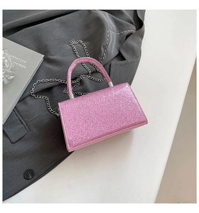Detail of pink sequin evening bag featuring glitter texture and silver chain strap