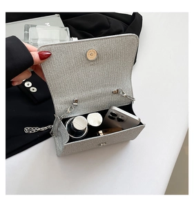 Detail of silver glitter crossbody bag showing interior capacity and magnetic closure
