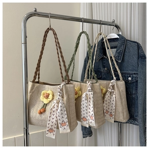Handwoven straw tote bag with floral accents and patterned scarf in three handle colors