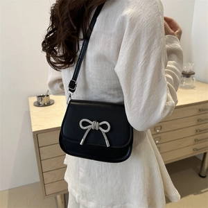 Chic black leather crossbody bag featuring a silver rhinestone butterfly bow buckle decoration