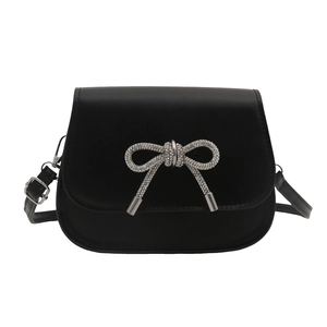 Minimalist black leather crossbody bag featuring a sparkling rhinestone butterfly decoration