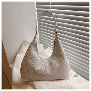 Close-up of cream woven hobo bag showing detailed texture and high-quality PU leather