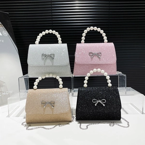 Chic glitter handbags with pearl handles and metal bows in silver, pink, gold, and black