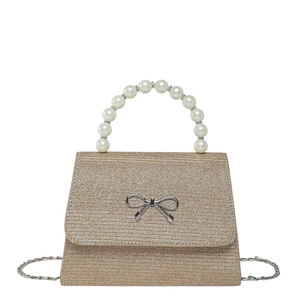Elegant gold glitter evening handbag with pearl handle and silver bow for women