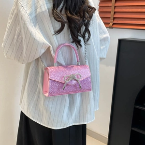 Pink sequin evening bag with silver rhinestone bow and metal chain strap