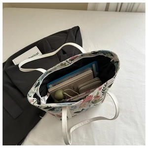 Interior view of large floral jacquard tote bag showing storage capacity for daily essentials