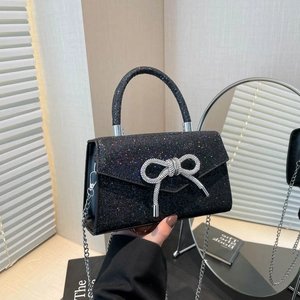 Elegant black evening bag with colorful sequins and a sparkling crystal bow decoration