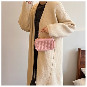 Detailed close-up of a pink embossed silicone handbag with a gold chain strap