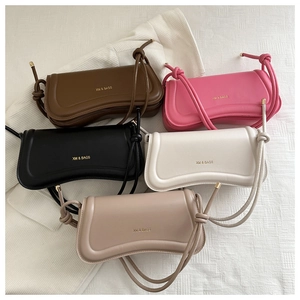 Close-up of stylish baguette bags with XM & BAGS gold lettering in multiple colors